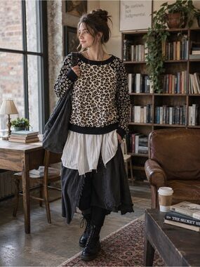Women’s SZ medium, black and white animal print sweater. Adds flare to an outfit